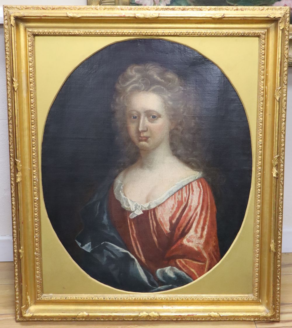 Early 18th century English School, oil on canvas, Portrait of a woman wearing a red dress, framed to the oval, 74 x 60cm